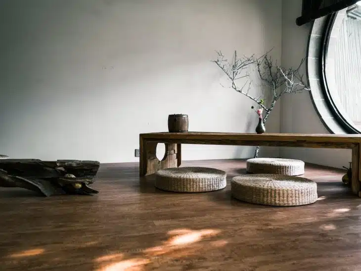 brown wooden bench near window